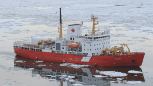 Icebreaker navigating sea ice in Canada's Arctic, where infrastructure must withstand extreme conditions